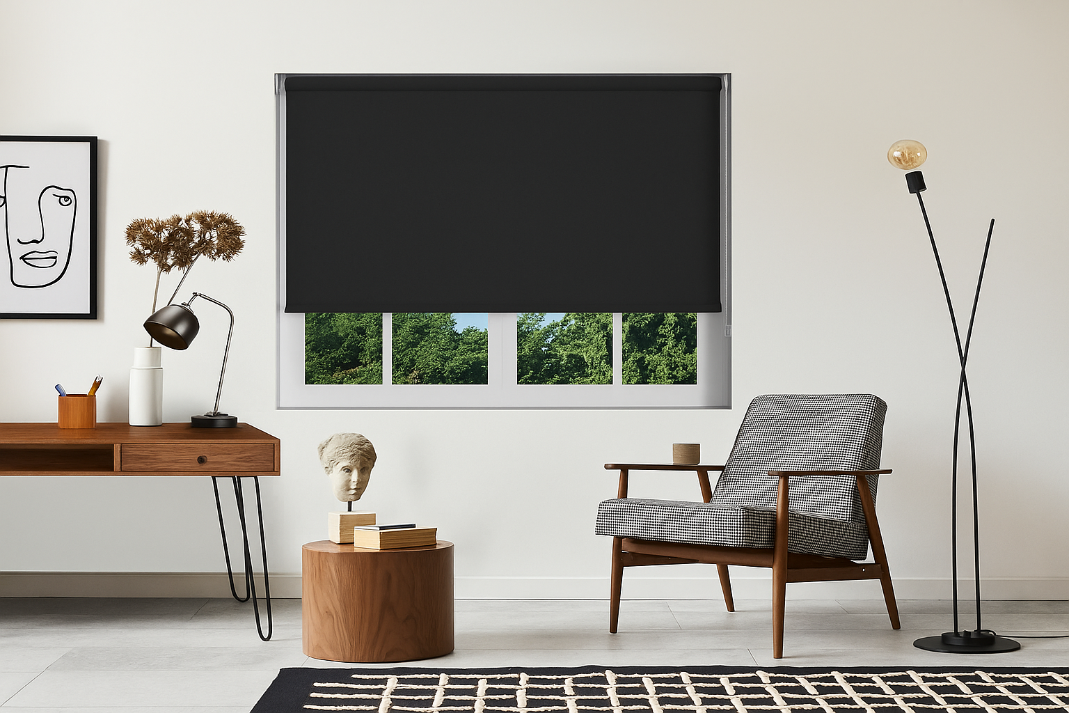 A stylish modern living room with a wooden desk, black roller blind, mid-century chair, and neutral decor. The black blind partially covers a window showing green trees outside.